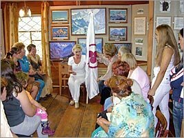 Alicia Rodriges tells about value of the Banner of Peace to visitors of the Roerich's museum of Uimon valley